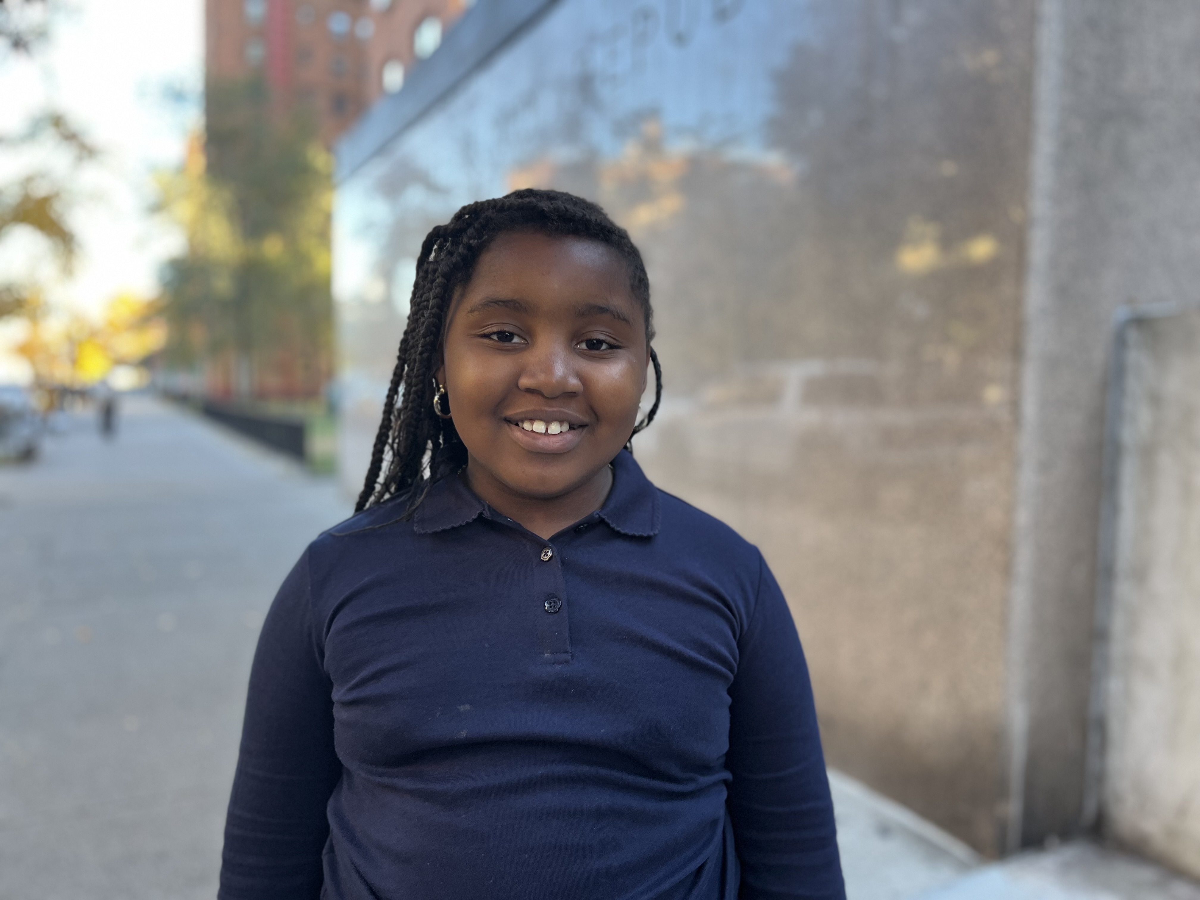 A young girl smiles for the camera.