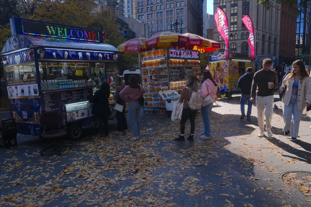 dry leaves on the ground next to a food cart