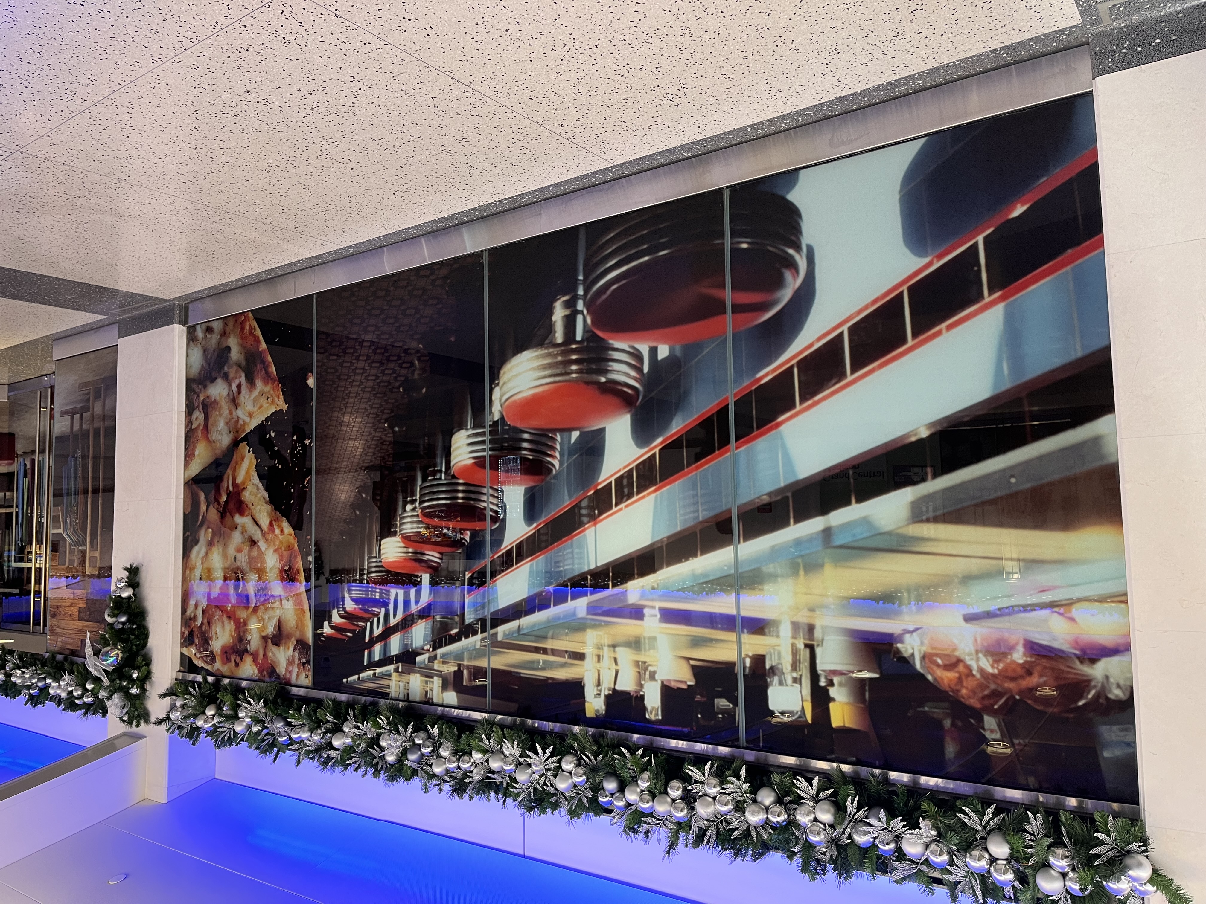 a stock image of a diner counter in a vacant storefront window at Grand Central Madison