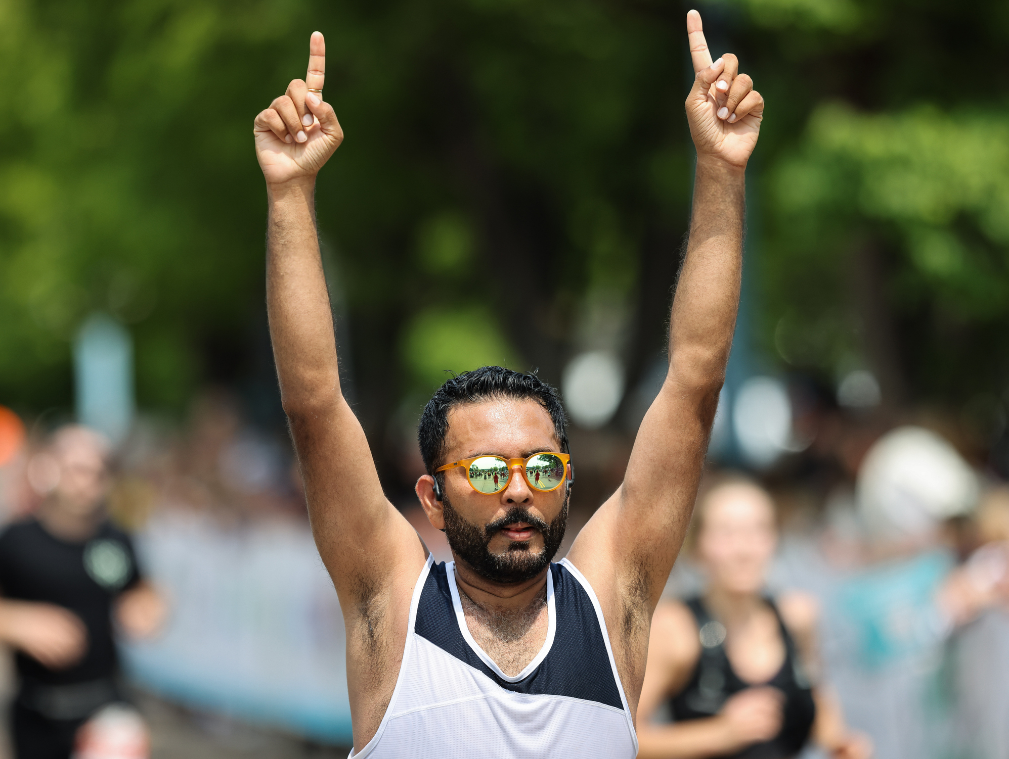 a runner celebrates at the finish line