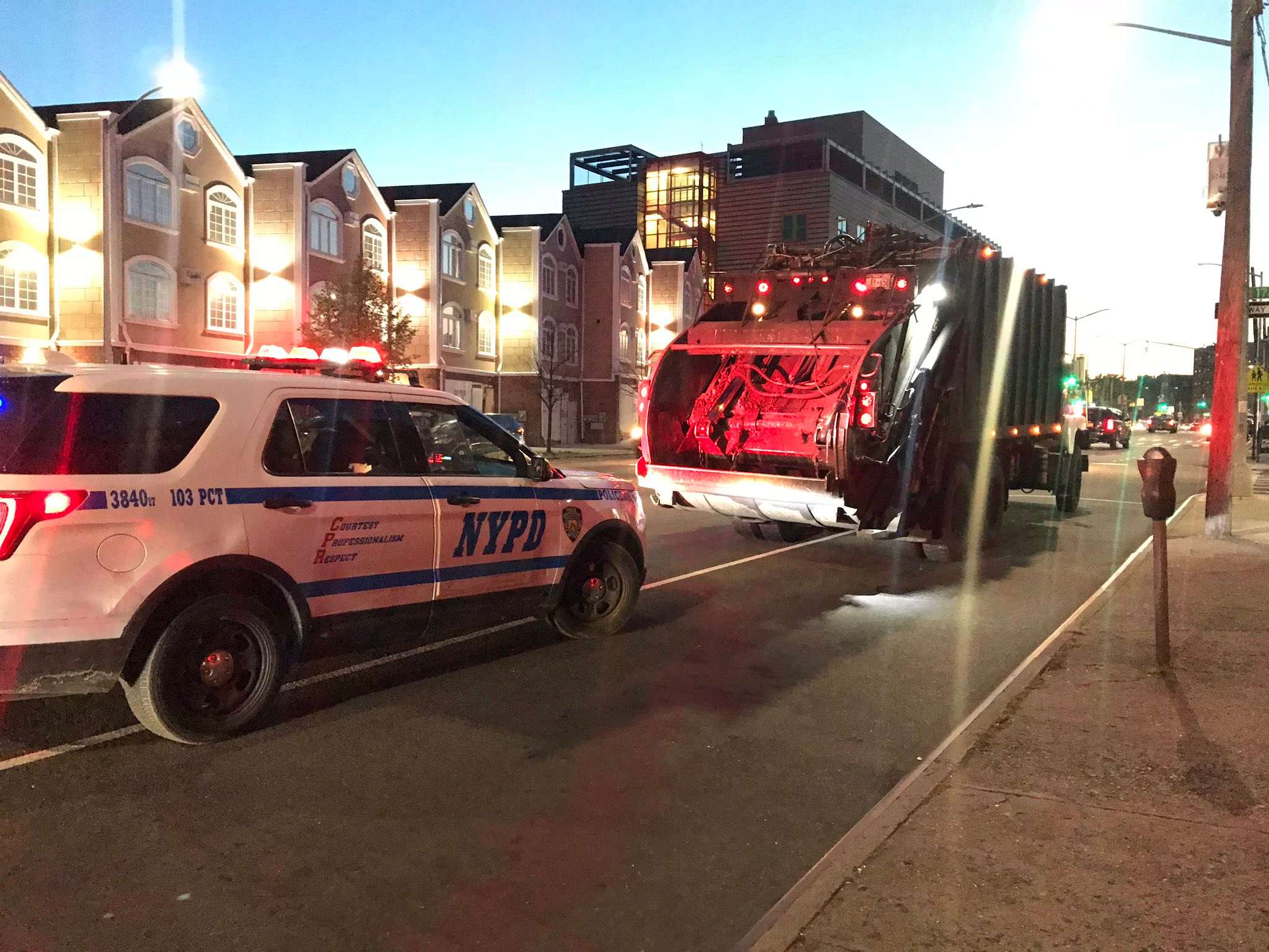 A police cruiser and a commercial waste truck.