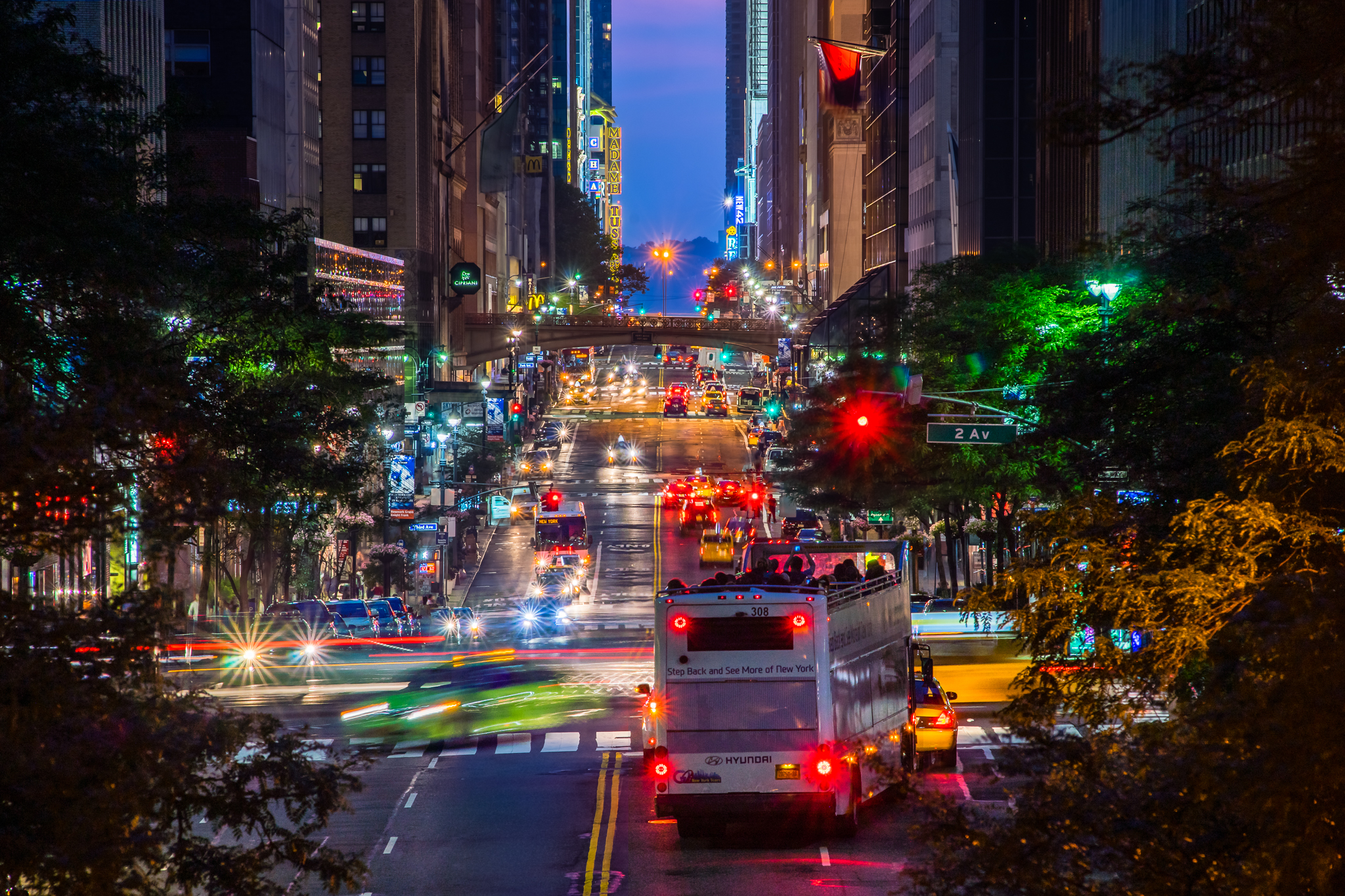 42nd Street in New York City, busy with vehicles at night, as seen from the Tudor City Overpass.