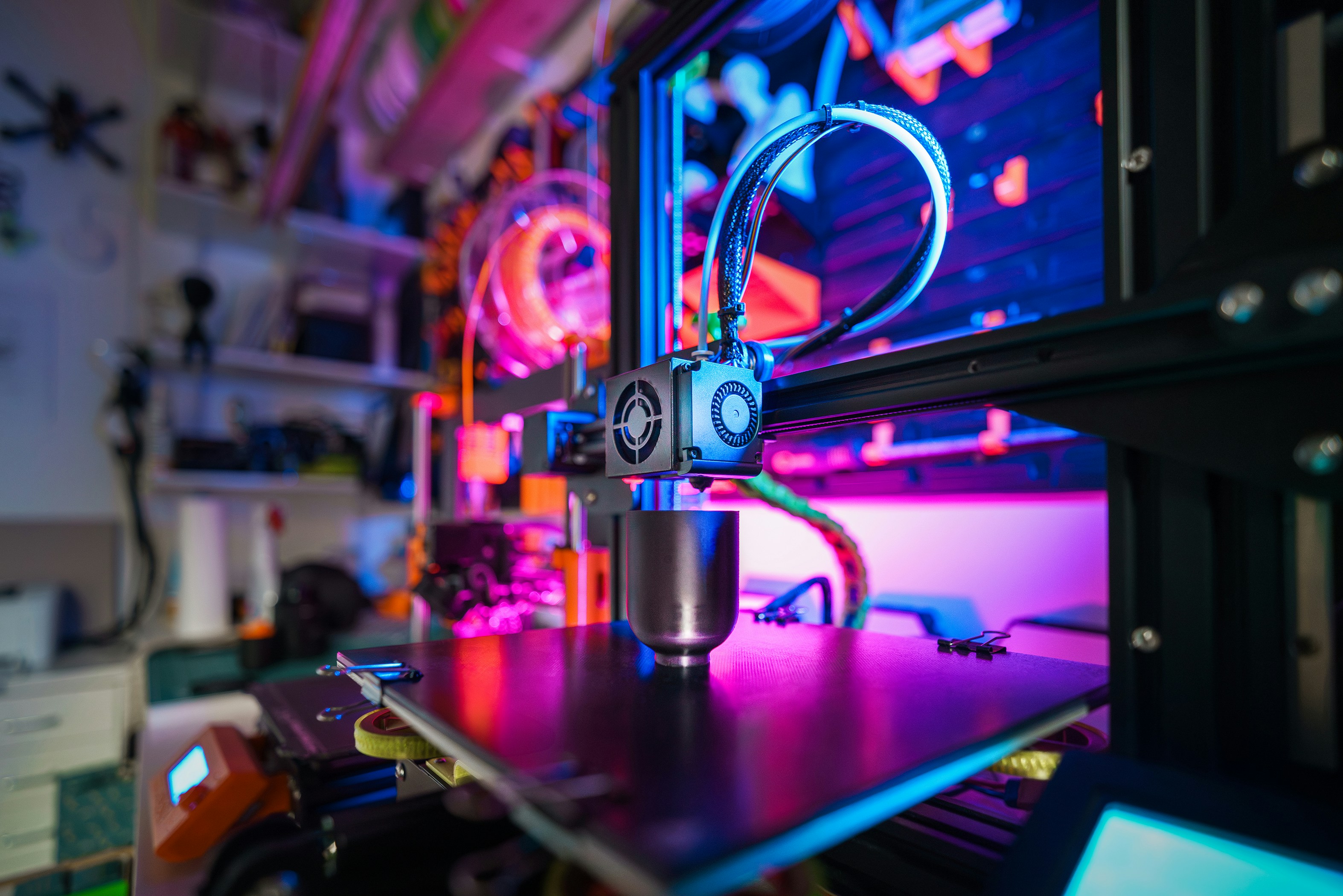 3D printer with a printed object on the table.