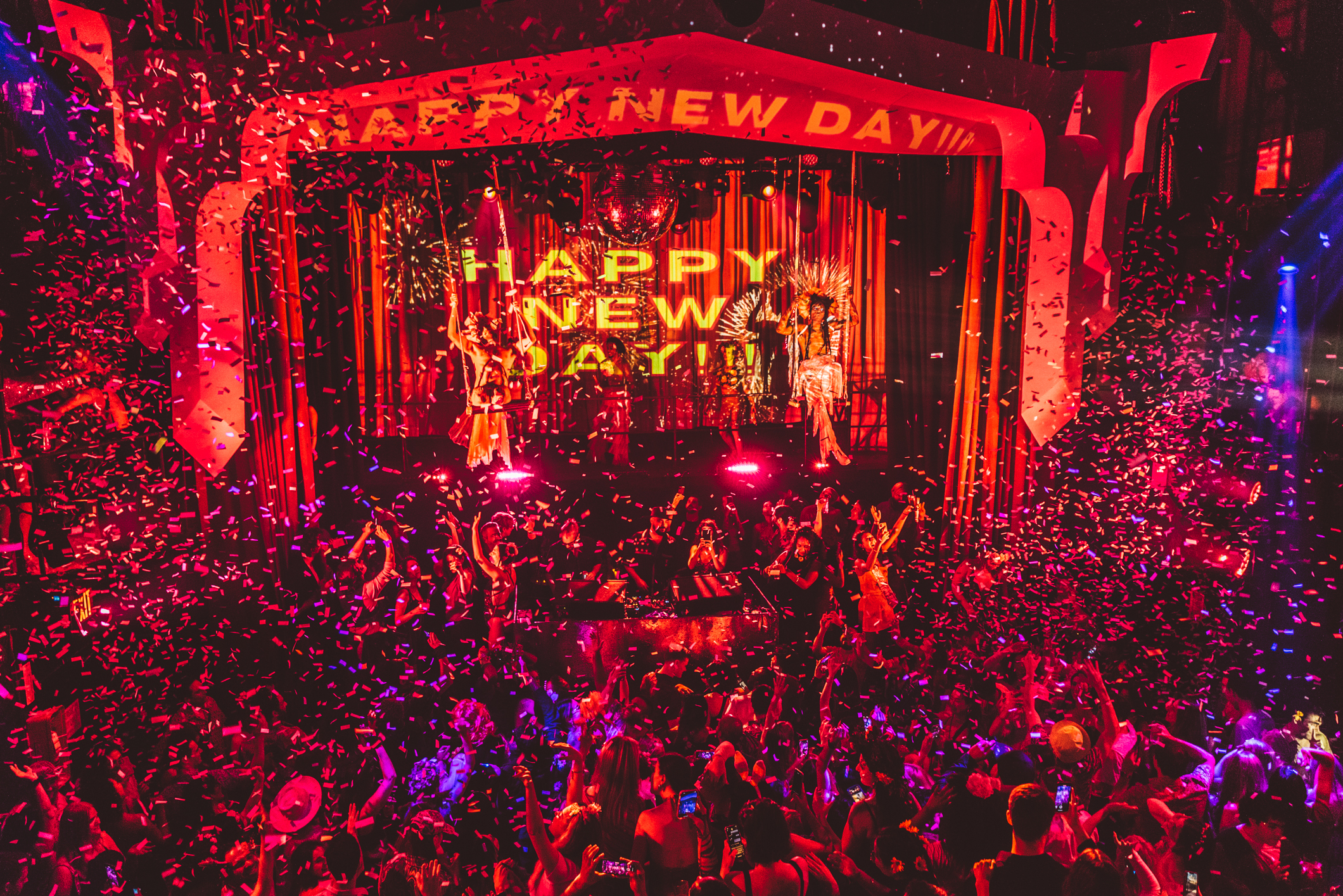 A group of people partying inside a club.