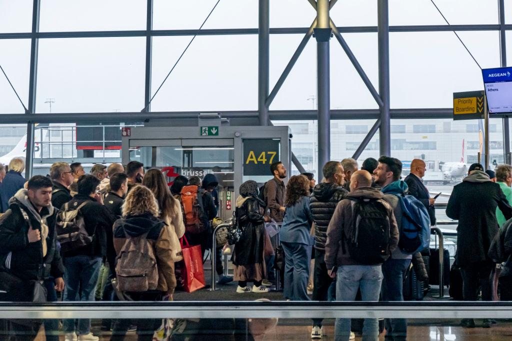 crowd trying to get on a plane