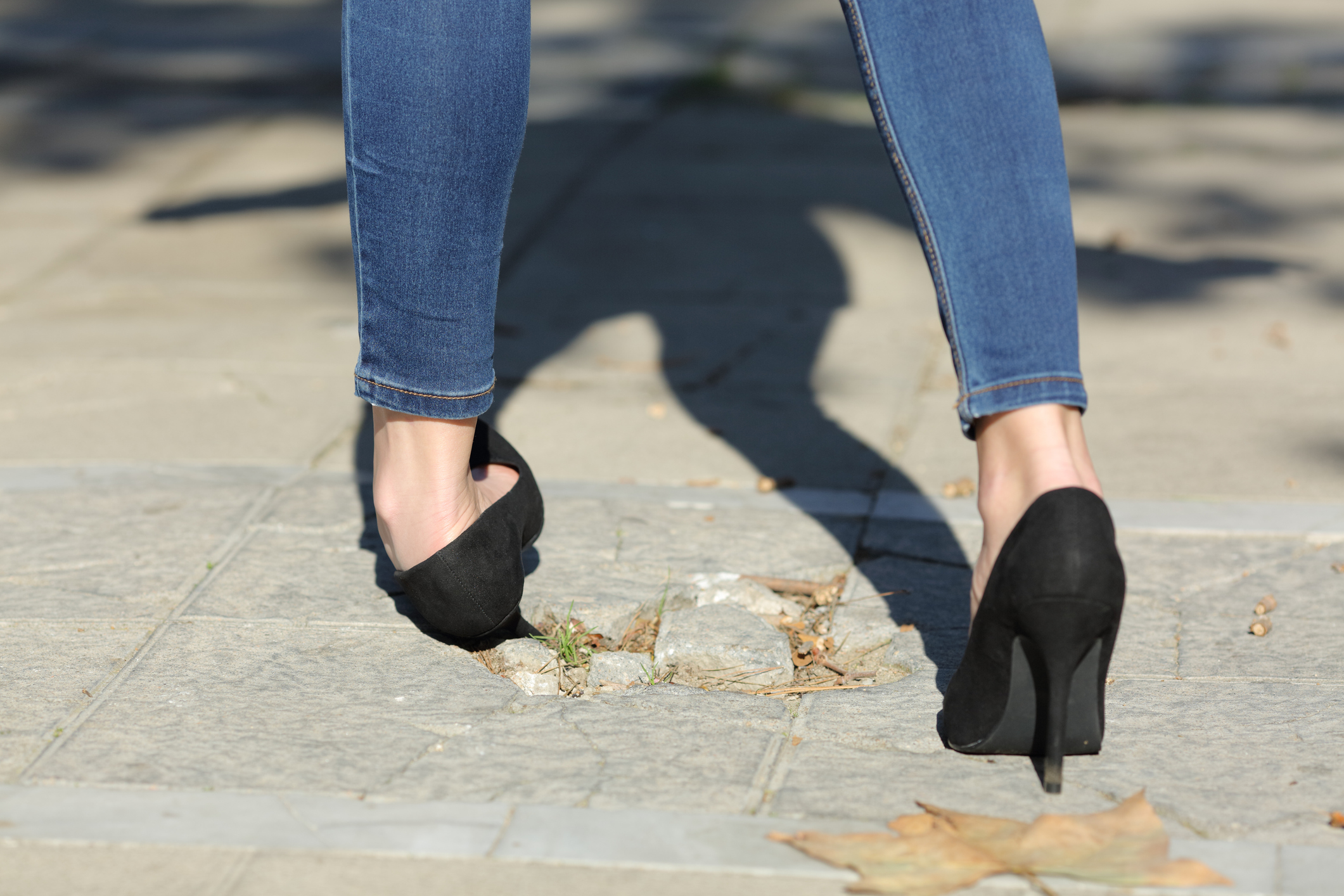 a broken high heel on the sidewalk