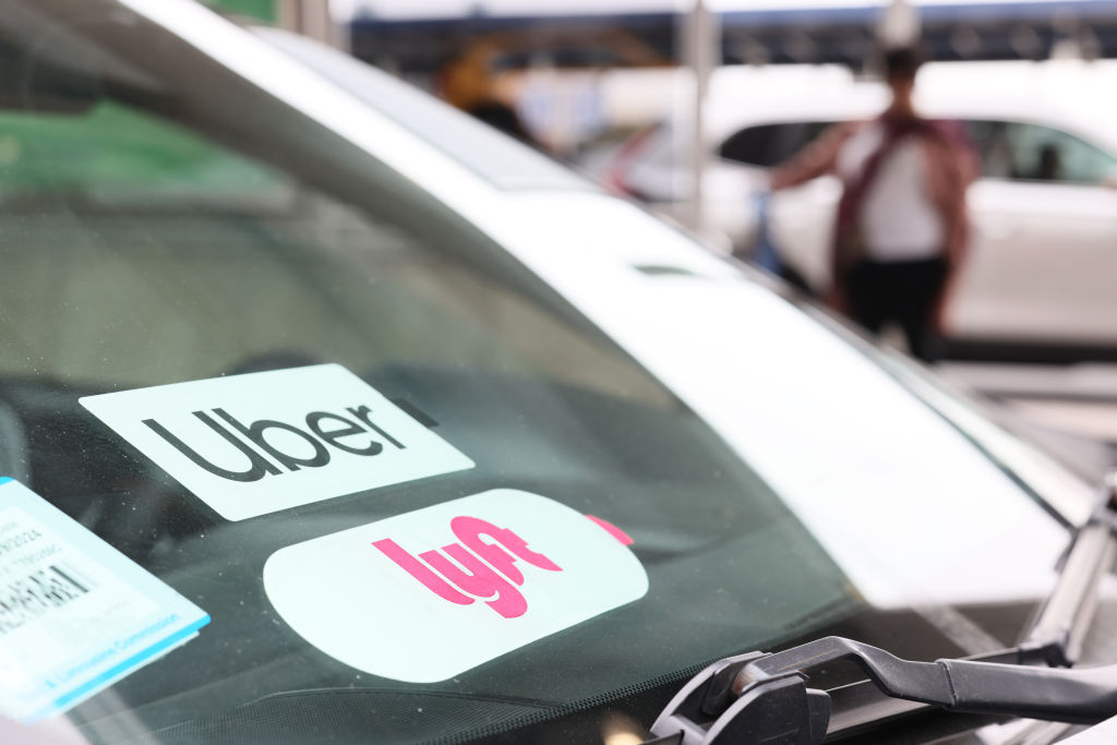 the windshield of a car with Uber and Lyft stickers